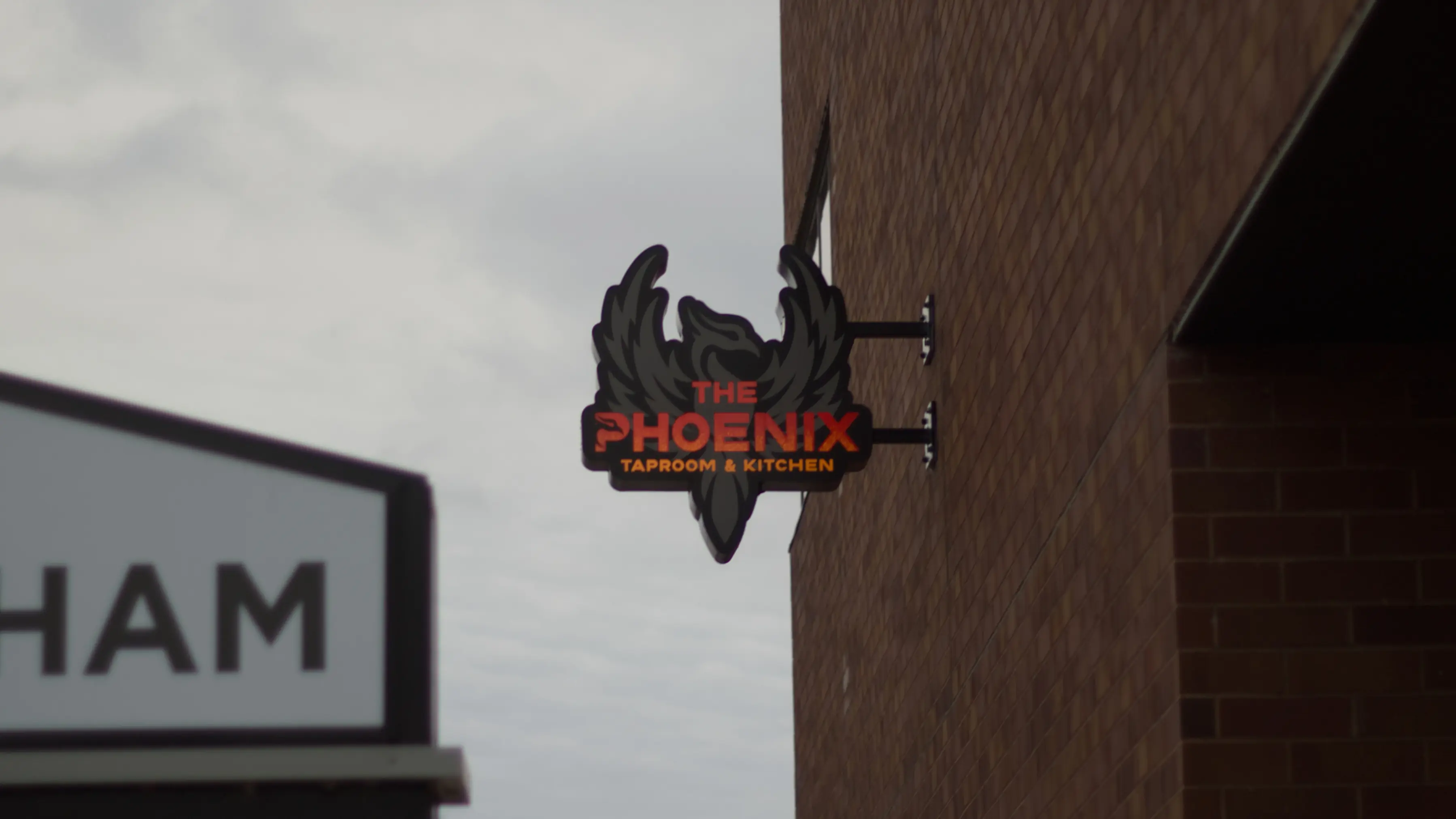 The Phoenix, Taproom and Kitchen. The logo outside.