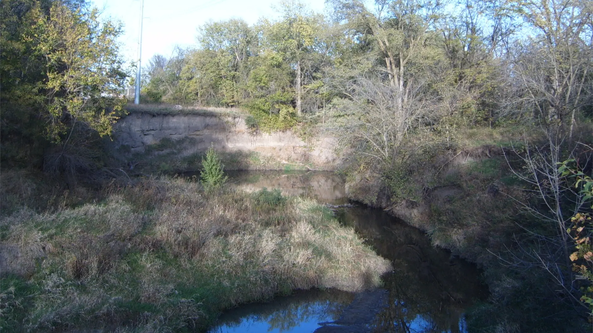 Walls of dirt surround a lake.