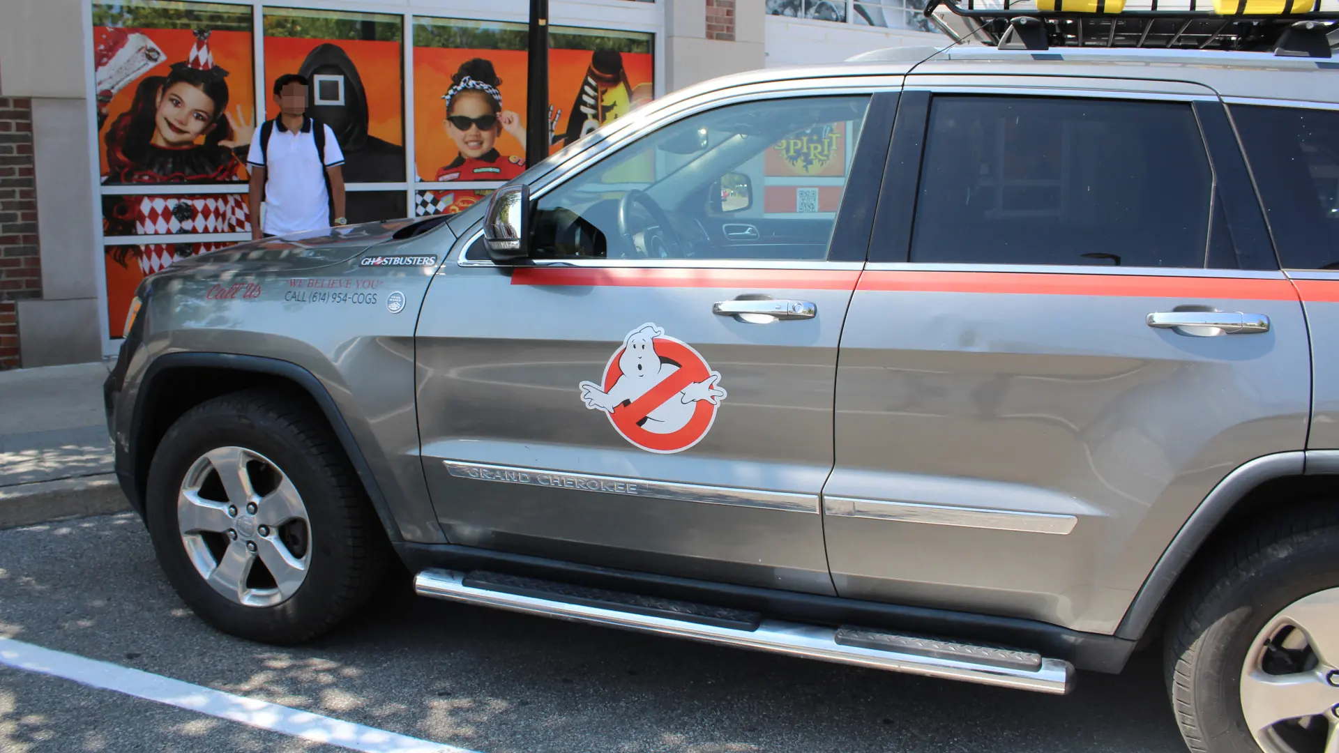A Jeep Grand Cherokee designed like the Ghostbusters car from the side.