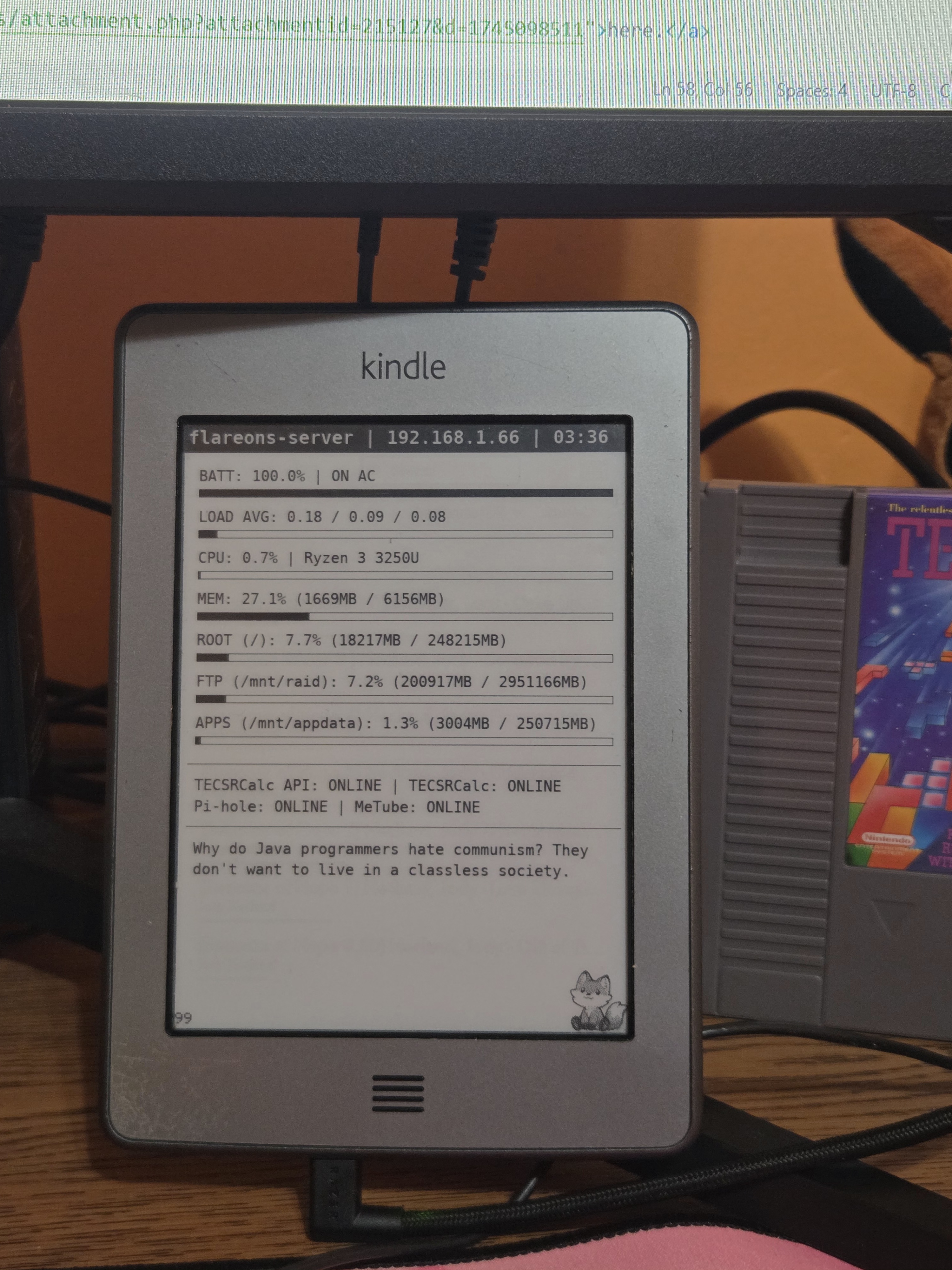 Black and White image of the backside of a Kindle Touch on a dresser.