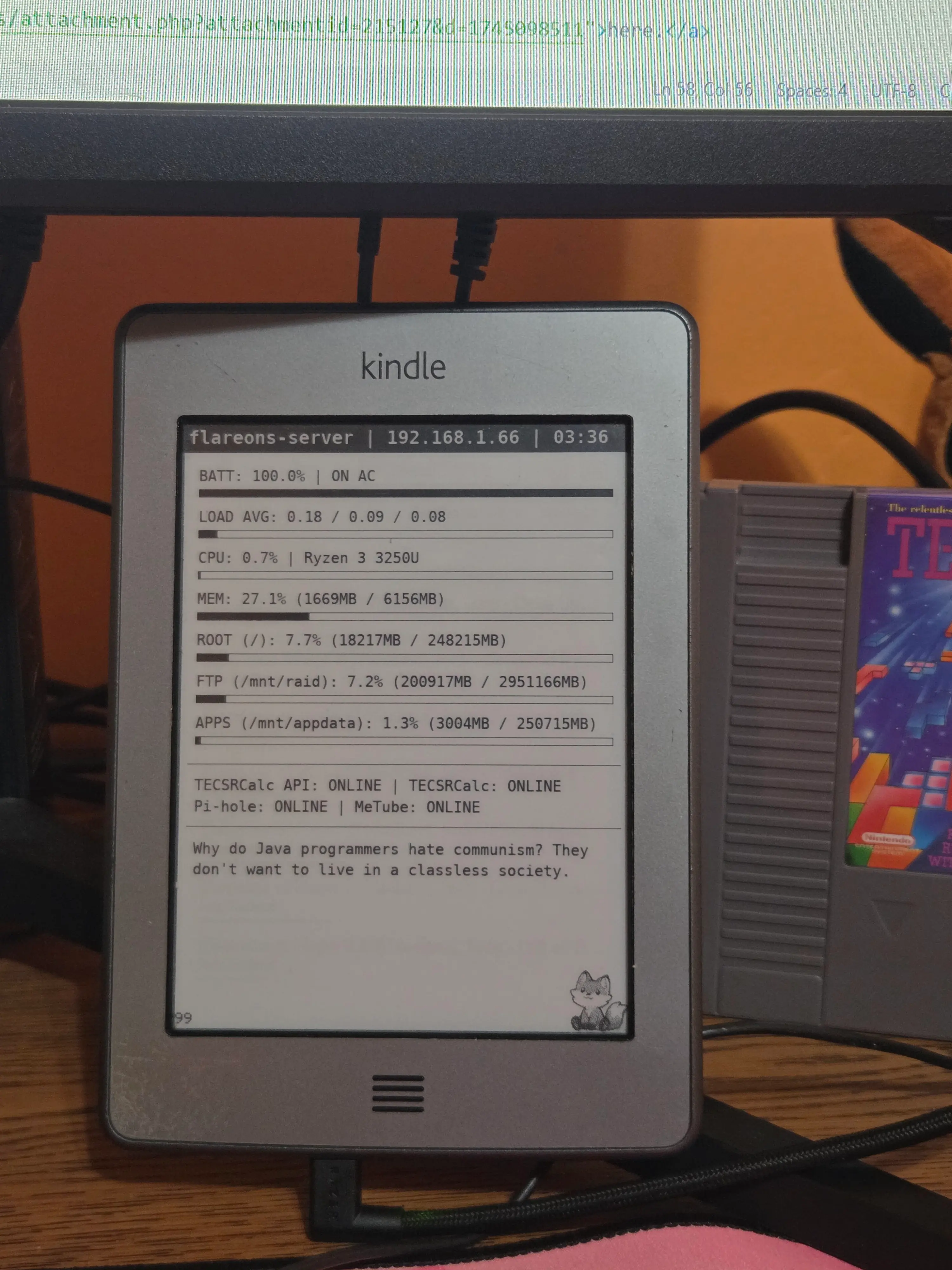 Black and White image of the backside of a Kindle Touch on a dresser.